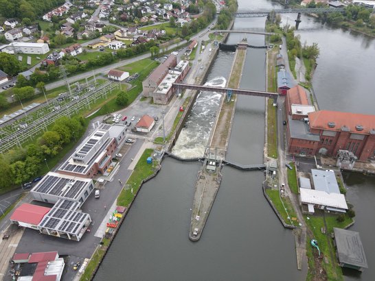 Water lock with operational buildings on both sides of the river